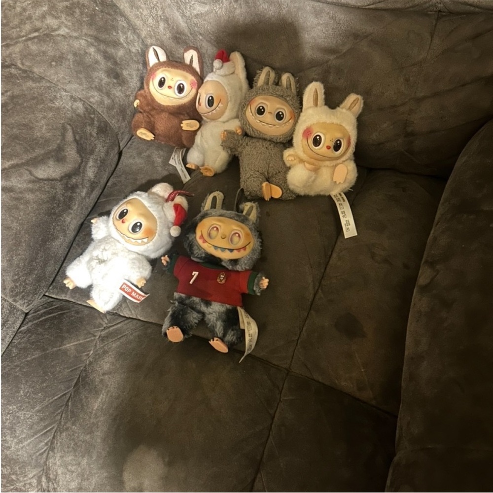 Multiple labubu plush toys with Christian Regalado out fit